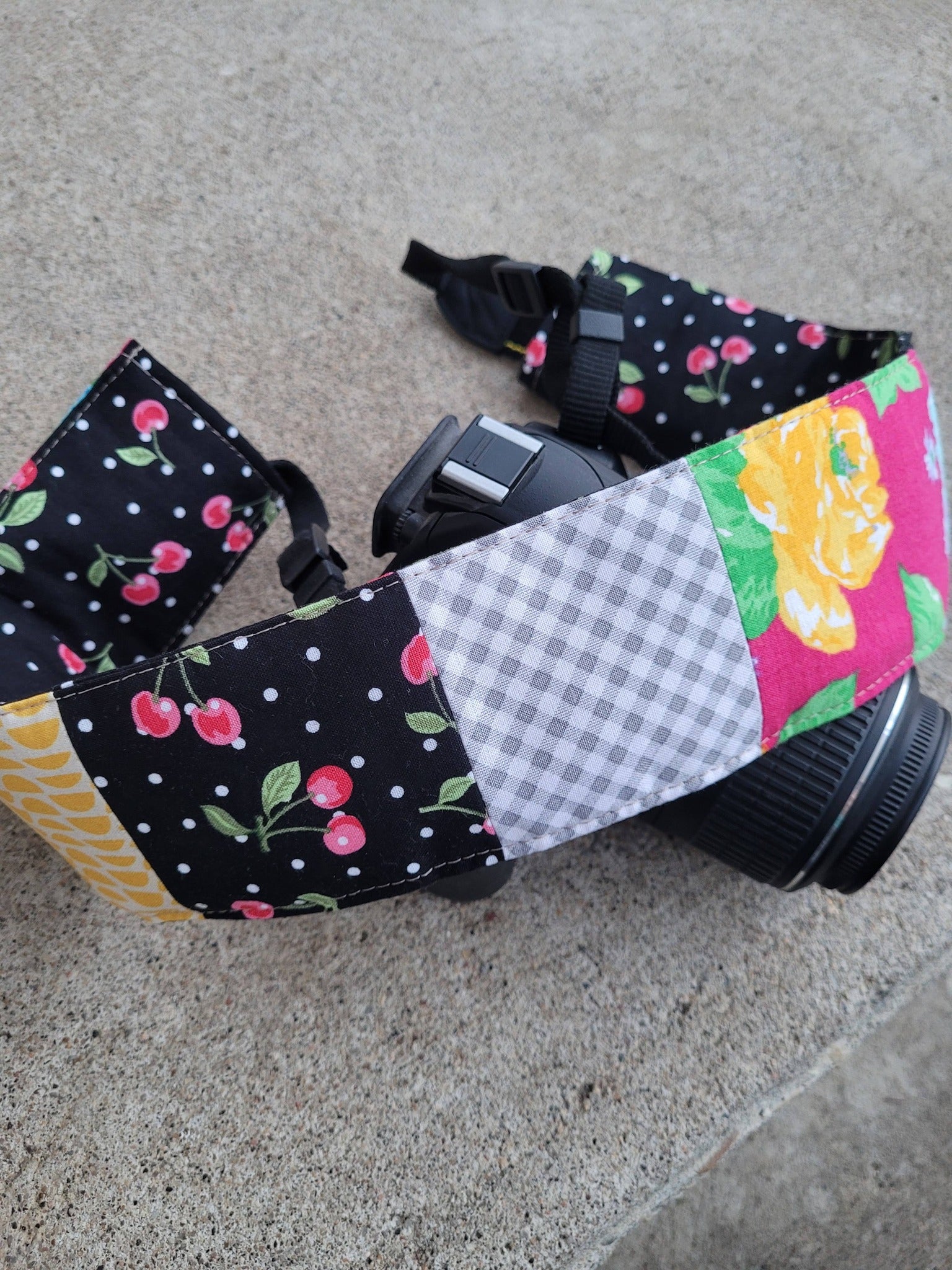 Camera strap cover with lens cap pocket.