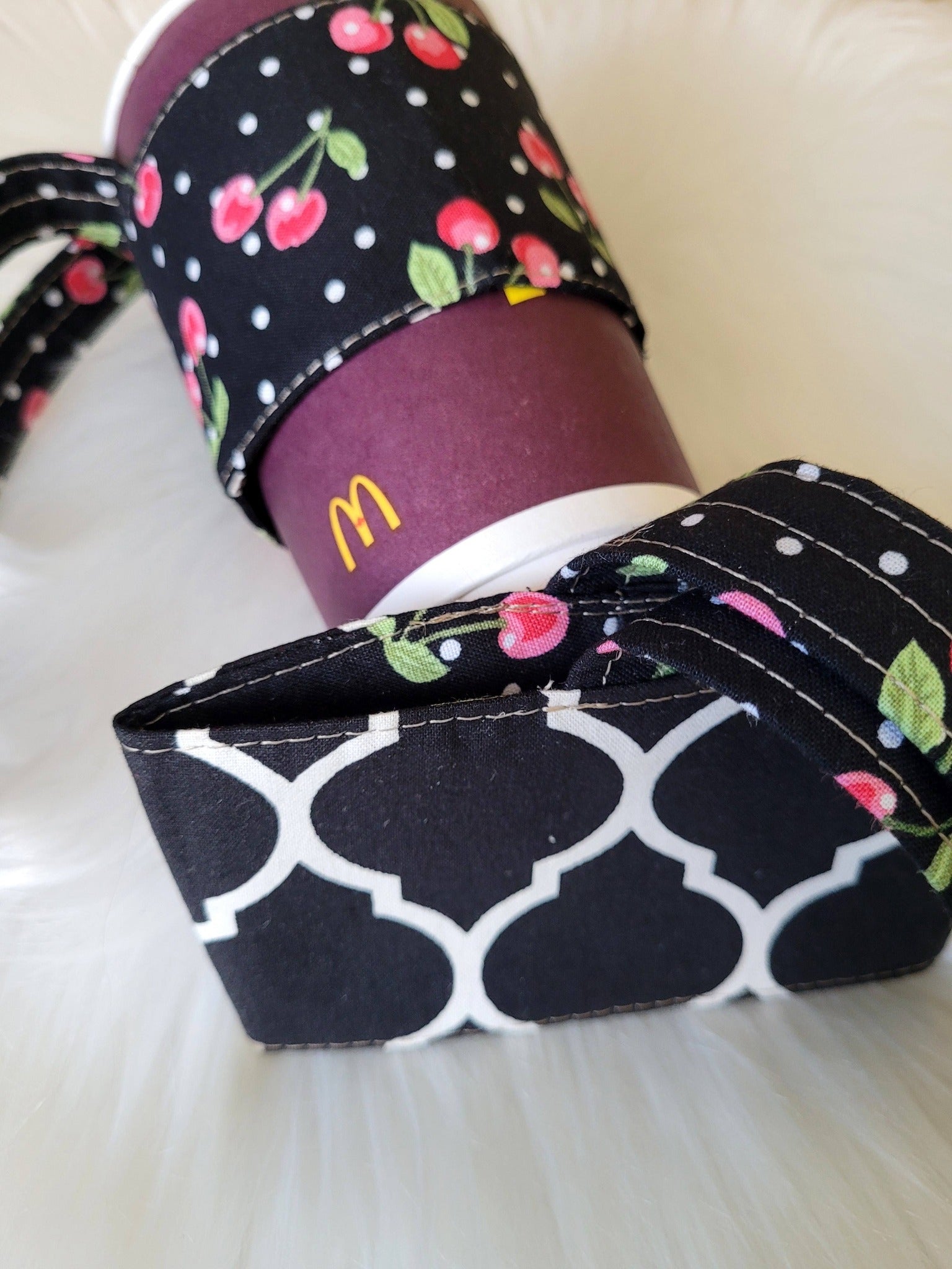 Cherry and black coffee cup carrier.