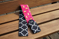 Camera strap cover with lens cap pocket.