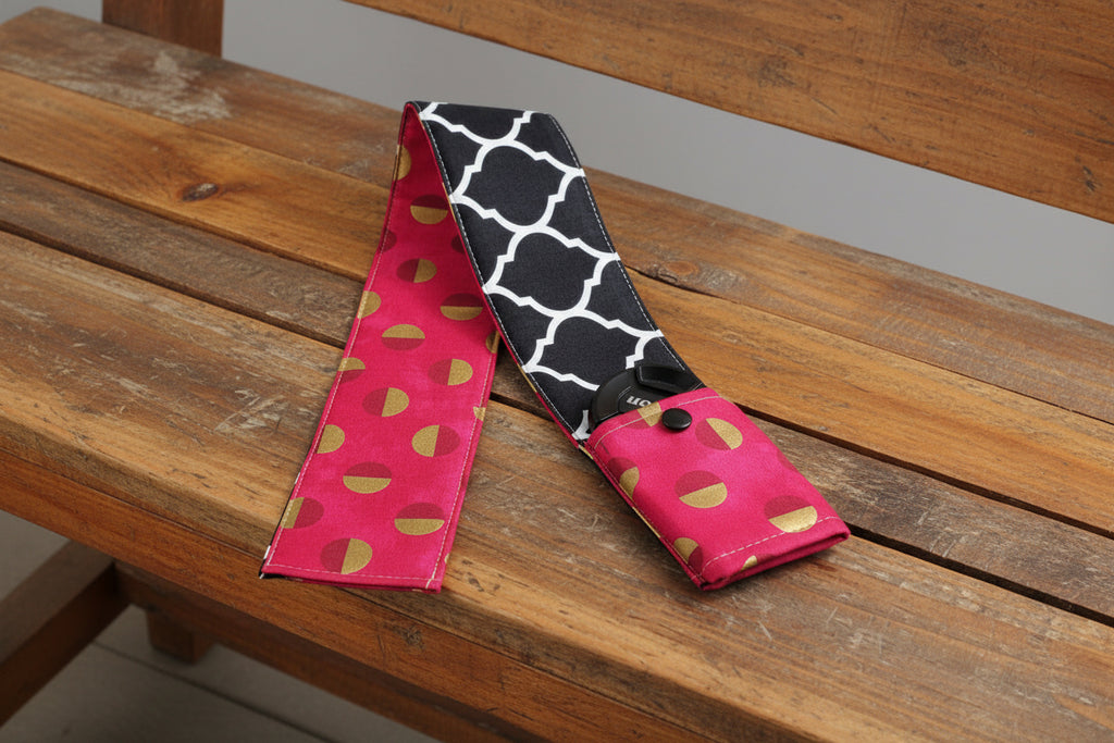 Camera strap cover with lens cap pocket